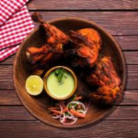 Spicy Tandoori Chicken · A soft, succulent dry dish made by slow roasting spiced and marinated chicken in a clay oven...