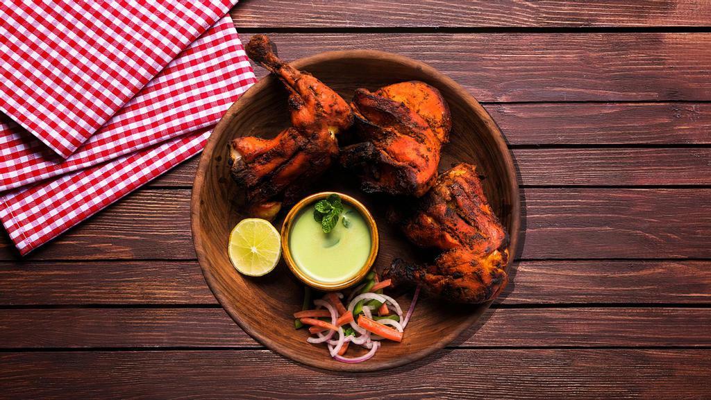 Spicy Tandoori Chicken · A soft, succulent dry dish made by slow roasting spiced and marinated chicken in a clay oven called tandoor.