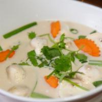 Tom Kha · A rich coconut soup with carrots, lemongrass, galangal, lime leaf, mushrooms, green onion, a...