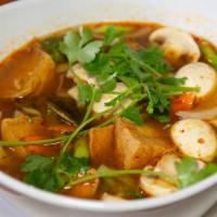 Tom Yum · Traditional Thai hot and sour soup with lemongrass, galangal, lime leaf, chili paste, mushro...