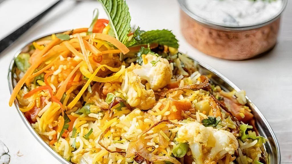 Vegetable Biryani · (GF) Hearty vegetables/meat and rice casseroles cooked with flavorful herbs & spices. Served with yogurt cucumber raita