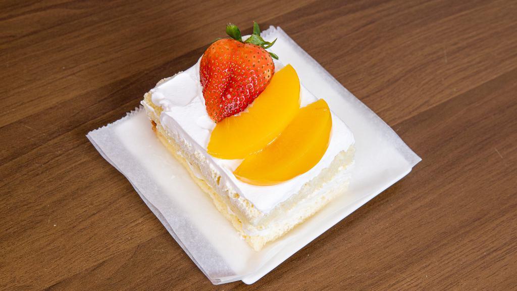 Tres Leches Slice Cake · With fruit on top.
