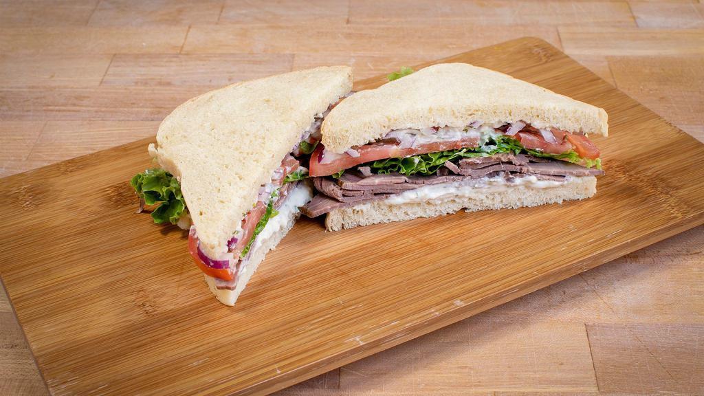 Pepper Bleu Roast Beef Sandwich Combo · Bleu cheese spread, roast beef, green leaf lettuce, tomato, red onion and pepper on your choice of bread. Served with a fountain drink and giant cookie.