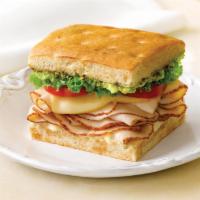 Turkey Bacon Avocado Sandwich · Served on sourdough roll with primo taglio turkey, bacon, avocado, tomato, lettuce, and ranc...