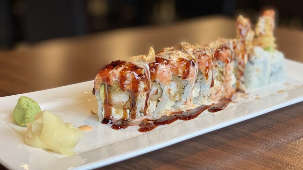 Texas Roll · Raw. Spicy. Shrimp tempura, cream cheese, avocado inside topped with spicy tuna, crab meat, tobiko, scallion & dry onion flake served with eel sauce & special yum yum sauce