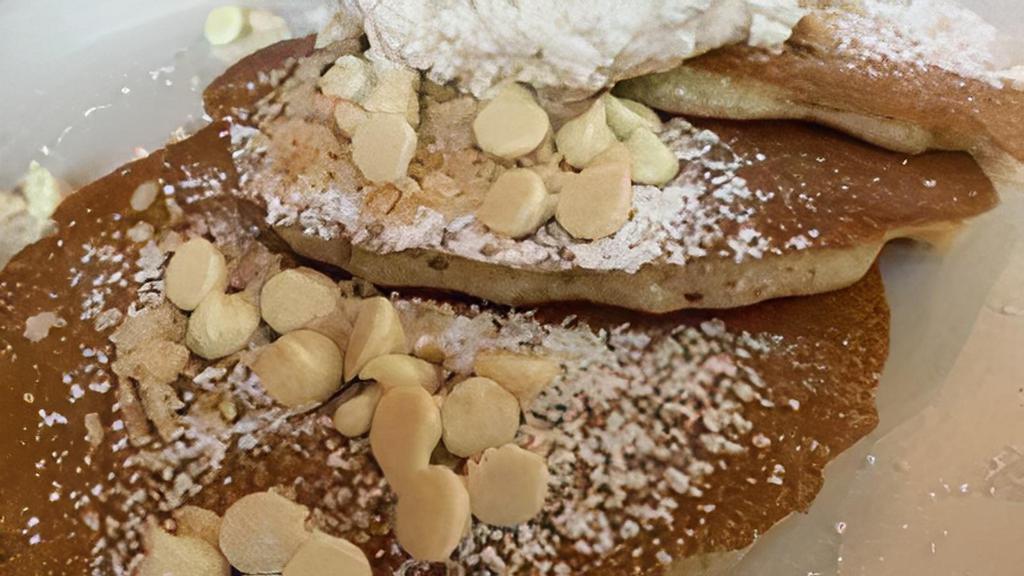Full Macadamia Pancakes · Six of our buttermilk pancakes filled with white chocolate chips. Topped with more chips and macadamia nuts. Served with a side of whipped cream and coconut syrup. Cal 1810