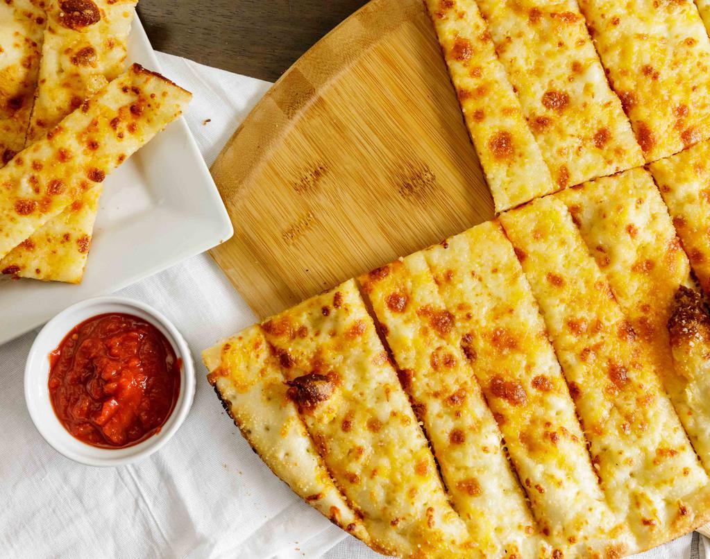 Cheesy Bread Sticks · Cheesy bread sticks is served with butter, cheddar cheese, mozzarella cheese, parmesan cheese.
