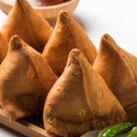 Vegetable Samosa · fried cone shaped pastry filled with spiced potatoes, onions, peas. Two pieces per order. Se...