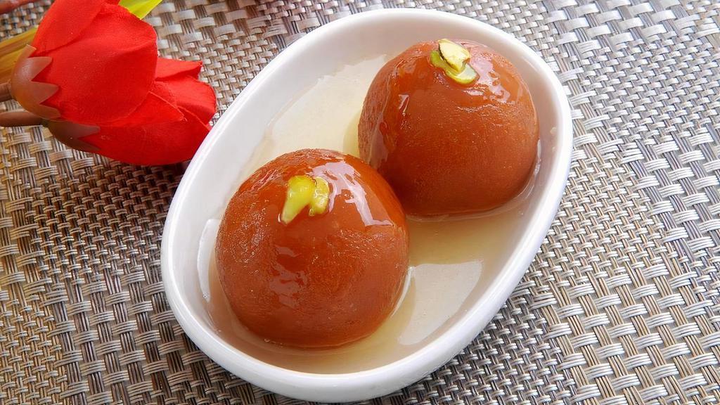 Gulab Jamun · deep-fried dumplings/donuts  made of dried milk are dipped in a cardamom flavored sugar syrup.