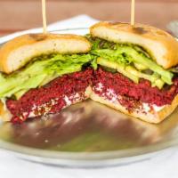 Un Beetable Burger · House-made beet-lentil-walnut patty, garlic aioli, local greens, chimichurri, topped with ho...