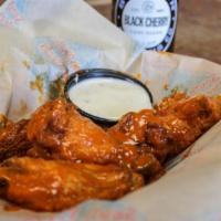 Wings · Classic or boneless. Sauced & tossed, served with ranch or blue cheese.