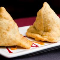 Samosa - Veg · Vegetarian. House favorite. Potato and peas cooked to perfection in a thin pastry cover.
