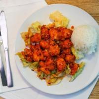 Volcano Chicken · Deep fried marinated chicken with sweet chili house sauce serve on top of lettuce with rice.