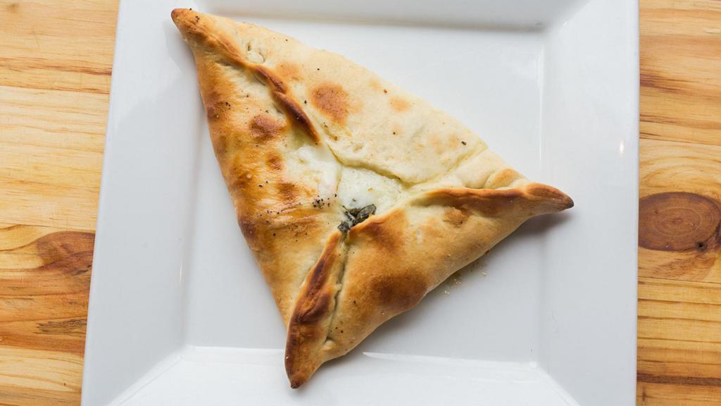Spinach Pie · Not gluten-free. Homemade dough with fresh spinach, onions, sumac, lemon juice and olive oil.