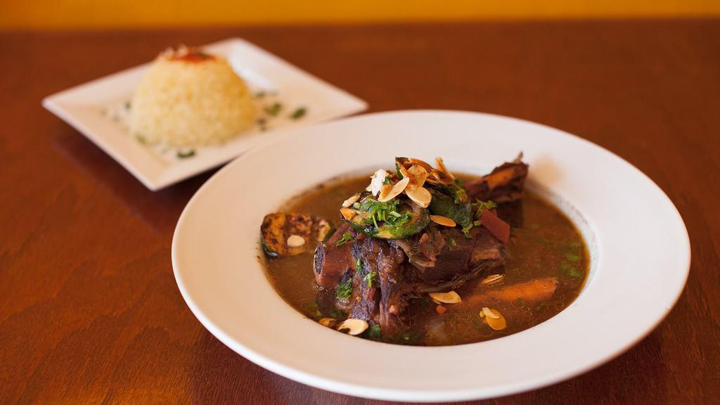 Lamb Shanks · Cooked to tender lamb shanks cooked to tenderness with pomegranate molasses marinated in our house seasonings, red wine and fresh basil. Served with house salad and basmati rice.