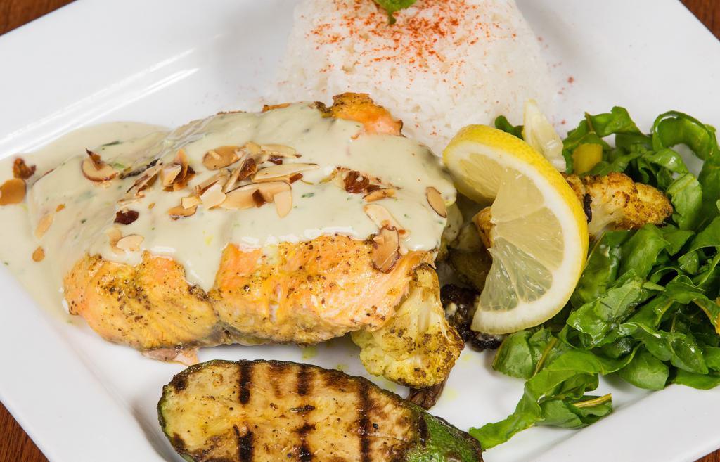 Grilled Salmon · Wild Grilled Salmon fillet marinated in garlic, dill, honey and lemon zest served with grilled zucchini , basmati rice and humos. Served with a house salad