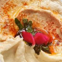 Hummus · A unique blend of chickpeas, tahini sauce, lemon juice and fresh garlic - served with olive ...