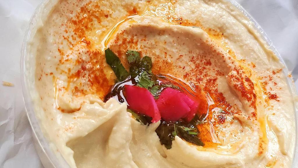 Hummus · A unique blend of chickpeas, tahini sauce, lemon juice and fresh garlic - served with olive oil.