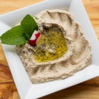 Baba Ghanouje · Local hand roasted eggplant mixed with tahini sauce, lemon juice and garlic - served with ol...