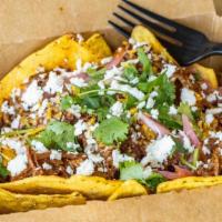 Beef Birria Nacho! · Spicy shredded beef, shredded cheese, pickled onions and cilantro.