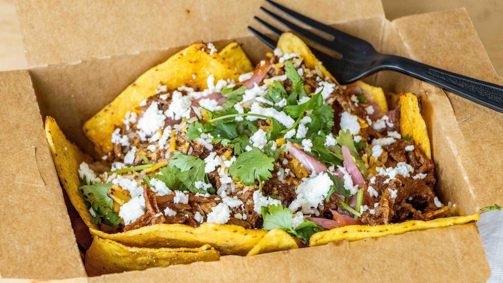Beef Birria Nacho! · Spicy shredded beef, shredded cheese, pickled onions and cilantro.