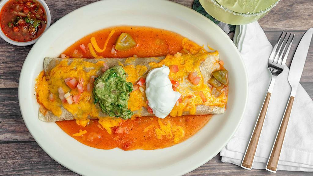 Ixtapa Burrito · House best seller! Probably our most famous dish! A flour tortilla filled with your choice of meat, topped with salsa, guacamole, sour cream and guacamole. (rice and beans inside).