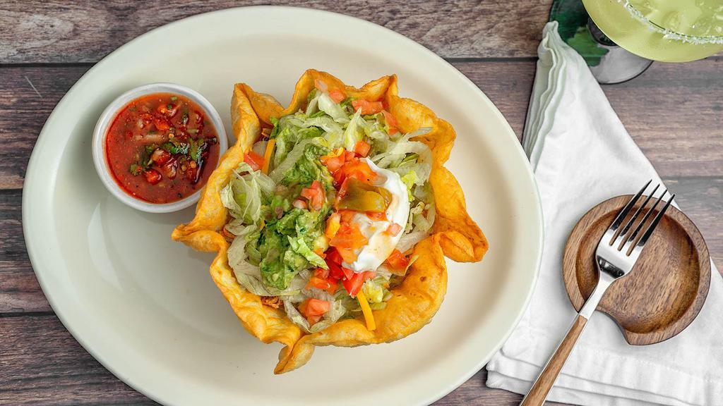 Ixtapa Taco Salad · Your choice of seasoned ground beef, chicken or picadillo with lettuce, cheese, guacamole, sour cream, tomato, and a mild sauce. Served in a crisp flour tortilla shell.