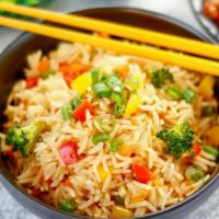 Veggie Fried Rice · Chopped seasonal veggies including carrots, peas, scallions and garlic with wok scrambled eg...