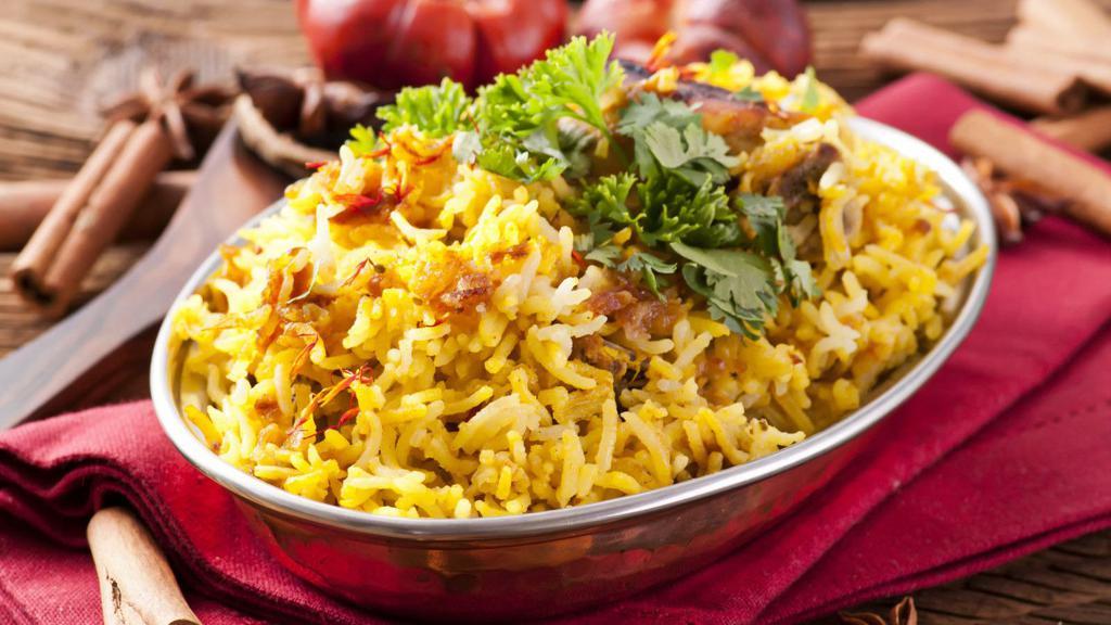 Chicken Biryani · Tender marinated chicken pieces cooked with aromatic, exotic spices and mixed with saffron infused basmati rice.