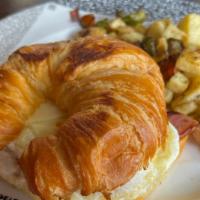The Giant Croissant · Ham egg and cheese with our breakfast potatoes.