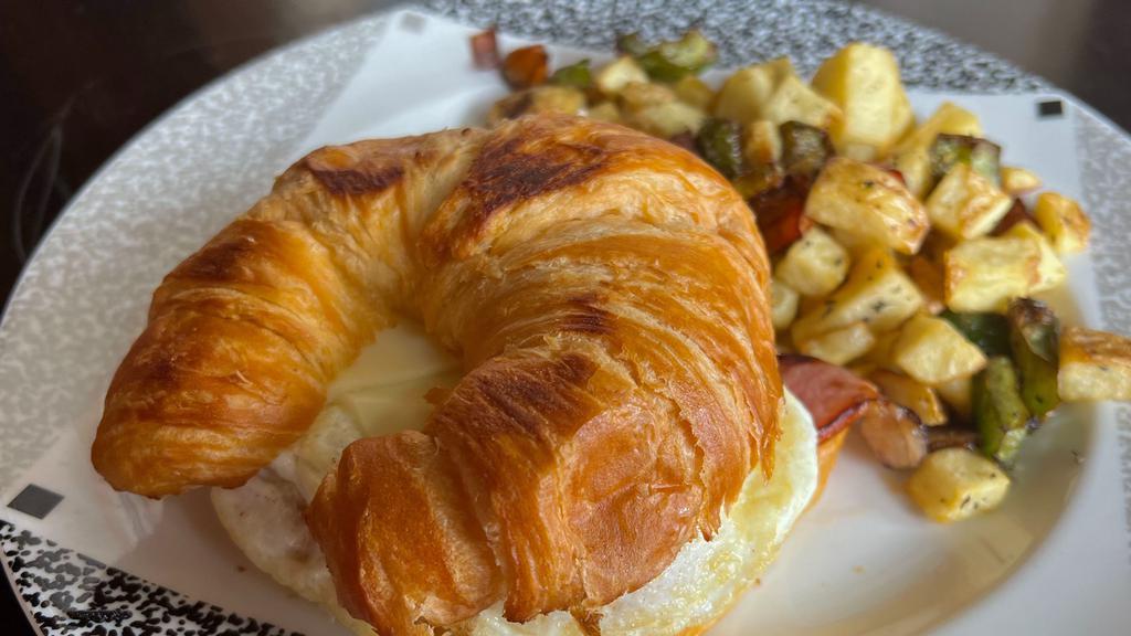 The Giant Croissant · Ham egg and cheese with our breakfast potatoes.