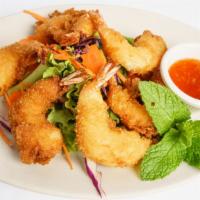 Crispy Coconut Shrimps · Deep-fried, battered tiger shrimp with crushed coconut served with sweet chili sauce.