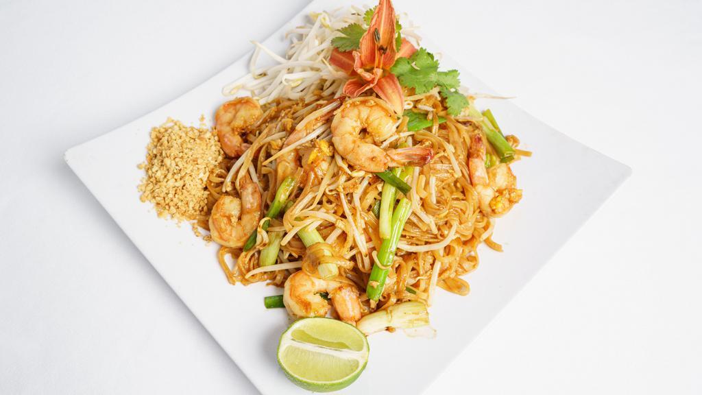 Shrimp Pad Thai · Fried rice noodles with shrimps, special pad thai sauce, eggs, bean sprouts, tofu and green onions, served with crushed peanuts and a lime slice on the side.