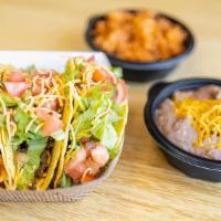 Taco Plate · 3 Tacos with choice of meat served with beans and rice.