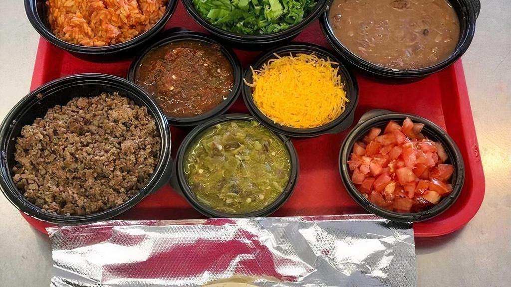 Diy Enchilada Family Kit · 2 Dozen Corn Tortillas, 16oz Cheese, 16oz Chile, 16oz Ground Beef or Chicken, 12oz Lettuce, 5oz Tomatoes, 5oz Onions, 16oz Whole Beans, 16oz Spanish Rice (served in containers and ready to make it yourself)