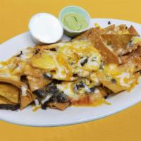 Nachos · Tortilla chips covered with your choice of meat and melted cheese, served with sides of guac...