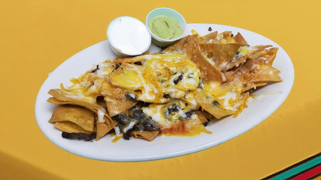 Nachos · Tortilla chips covered with your choice of meat and melted cheese, served with sides of guacamole and sour cream.