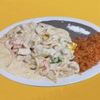 Pollo A La Crema  · Served with rice and beans.