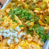 Chicken Nachos · nacho cheese , cilantro , onions , jalapeños