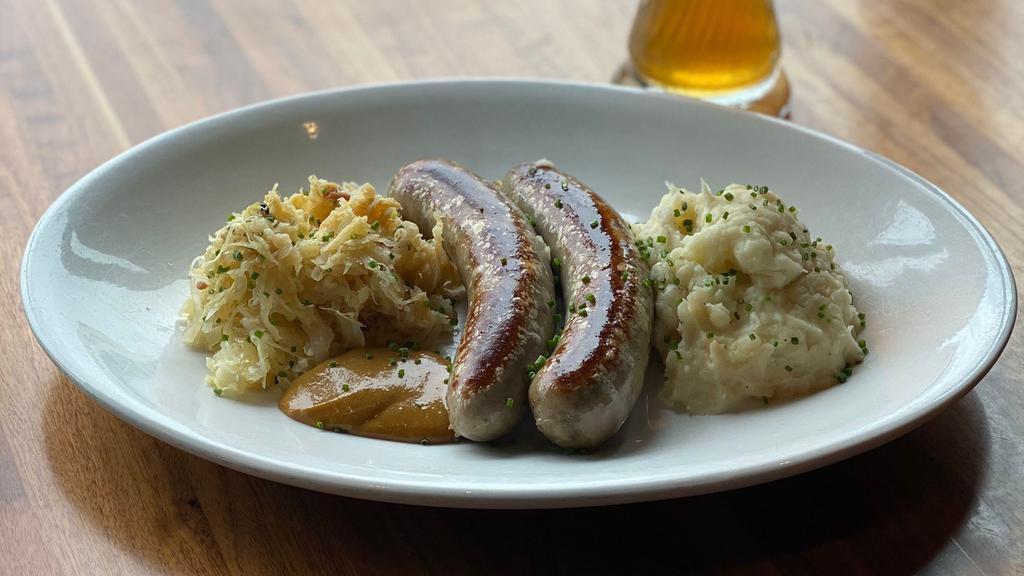 Bratwurst Sausage Dinner · A traditional Bavarian-style bratwurst served with dijon mustard, served with mashed potatoes and pineapple sauerkraut.