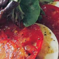 Caprese · Sliced tomato, fresh mozzarella and basil with side of balsamic vinaigrette