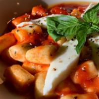 Gnocchi Sorrentina · Handmade ricotta gnocchi in fresh tomato sauce with mozzarella and basil.