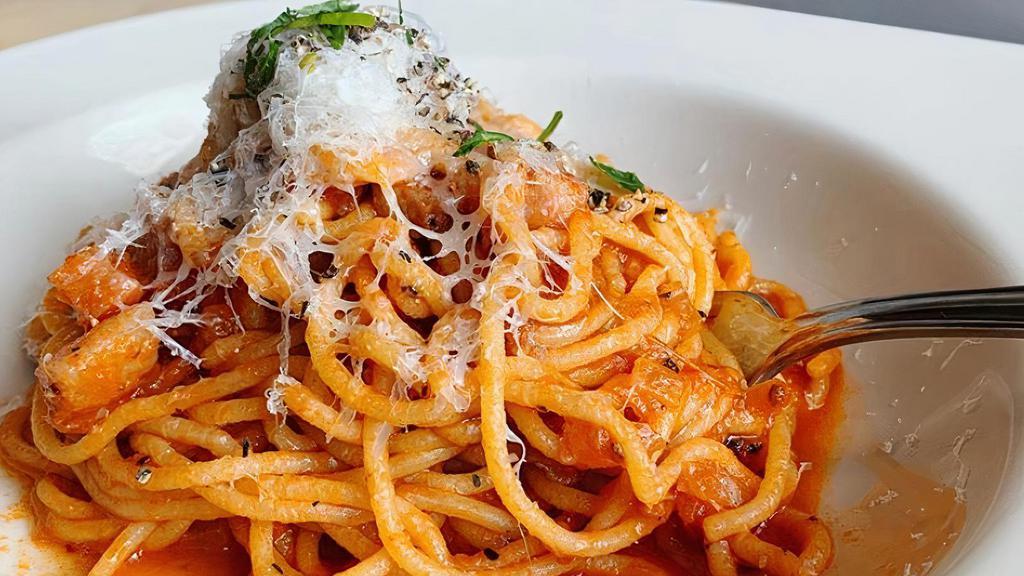 Spaghetti Amatriciana · Diced pancetta and onion in a spicy tomato sauce with parmigiano.