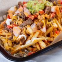 Carne Asada Fries · Golden fries loaded with carne asada, guacamole, cheese, and sour cream.