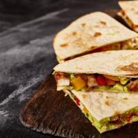 Carne Asada Quesadilla · Juicy steak and melted cheese folded into a warm flour tortilla, served with a side of guaca...