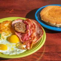 Breakfast Combo · 2 buttermilk pancakes, 2 bacon, 1 sausage, 1 ham, hash browns and 2 eggs any style.