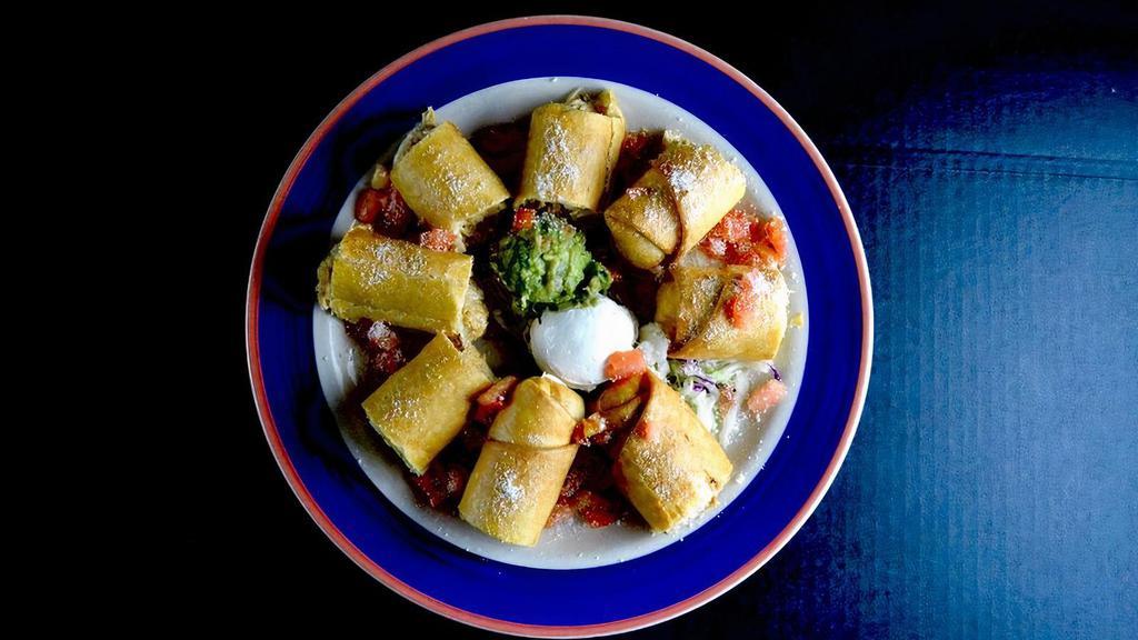 Chicken Taquitos · Two rolled flour tortillas stuffed with chicken and Jack cheese.served crispy. Garnished with tomatoes, Cotija Mexican cheese, sour cream and guacamole.