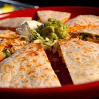 Quesadilla · Two crispy flour tortillas stuffed with Cheddar and Jack cheese, green onions and tomatoes. ...
