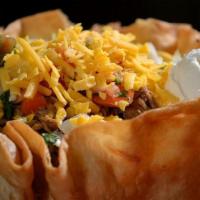 Deluxe Taco Salad · An Azteca favorite served with your choice of ground beef, chicken or picadillo. Layered wit...