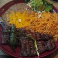Carne Asada · Thinly sliced, seasoned skirt steak, carefully charbroiled to perfection. Garnished with who...